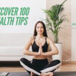 A girl practicing yoga in a serene setting, promoting wellness and inner peace. Discover 100 health tips for a balanced lifestyle.